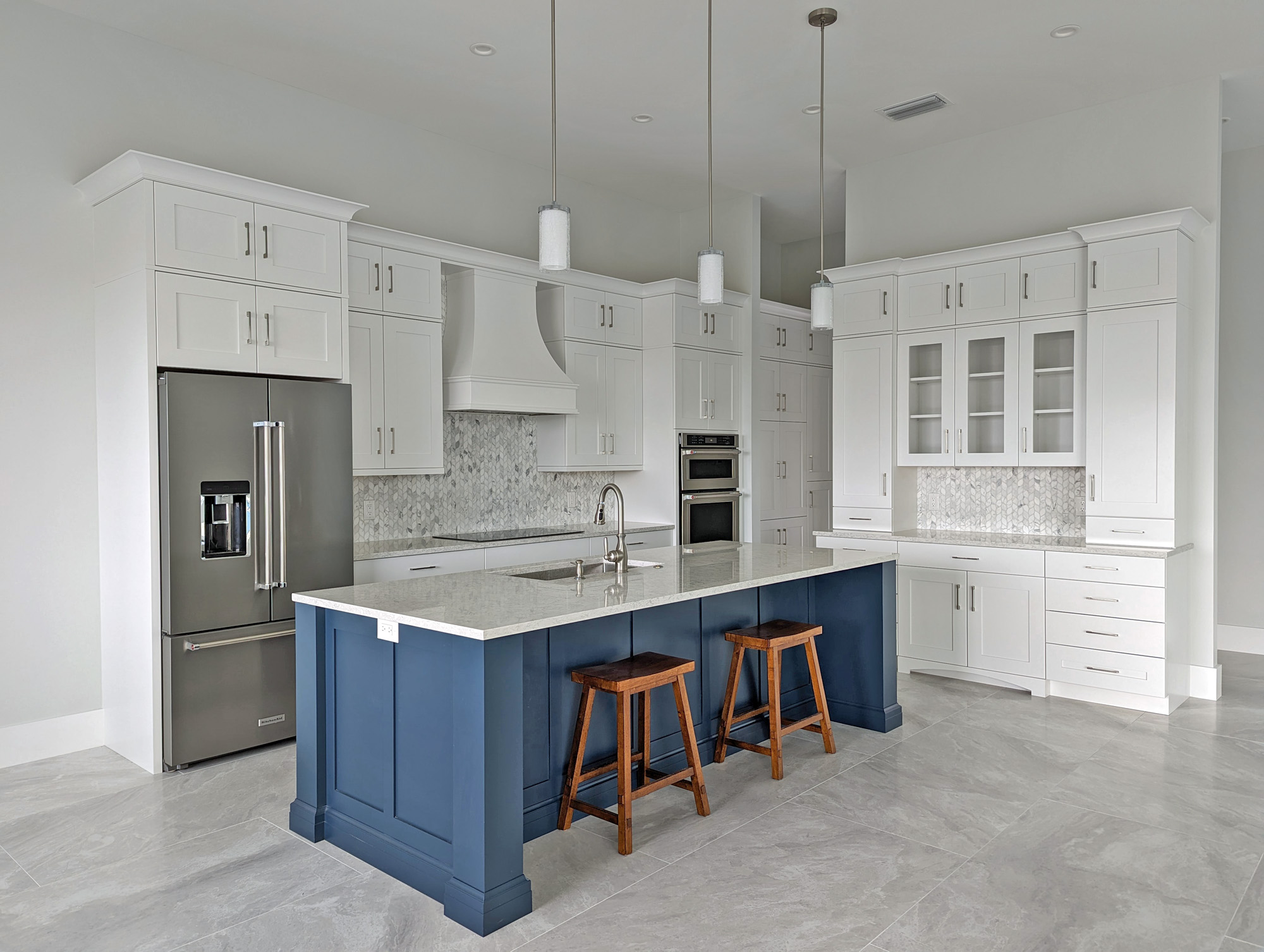White Kitchen Cabinets with Contrasting Blue Island Cabinet